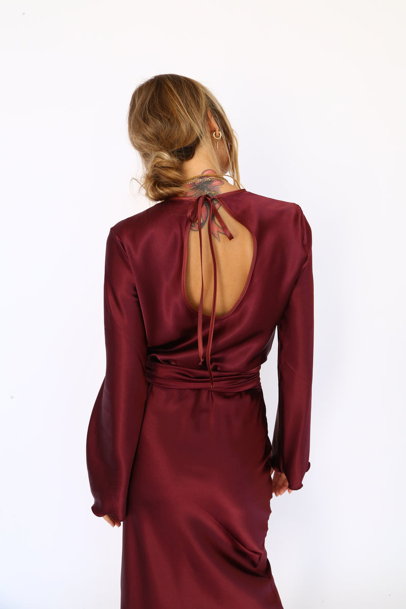 Burgundy satin midi dress with long sleeves and a keyhole back